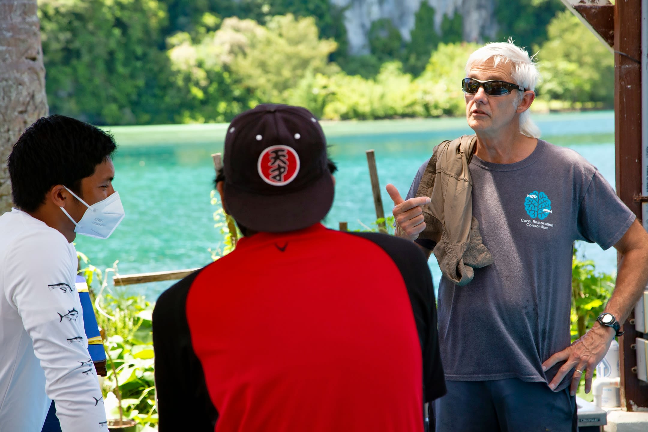 Stanford University marine biologist Dr. Steve Palumbi and Palau Community College students discuss prepping coral tissue for DNA sequencing at Palau International Coral Research Center in Koror, Palau. 